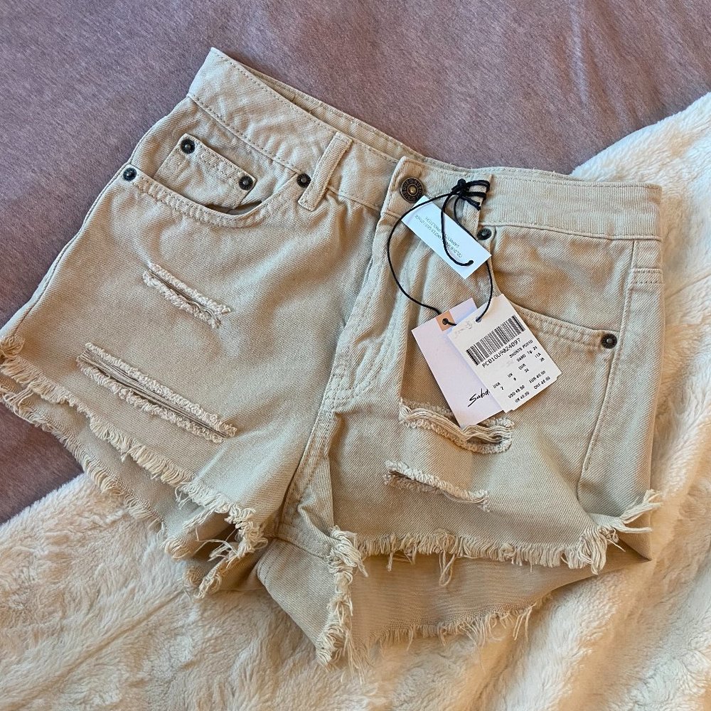 Subdued tan denim cut off shorts